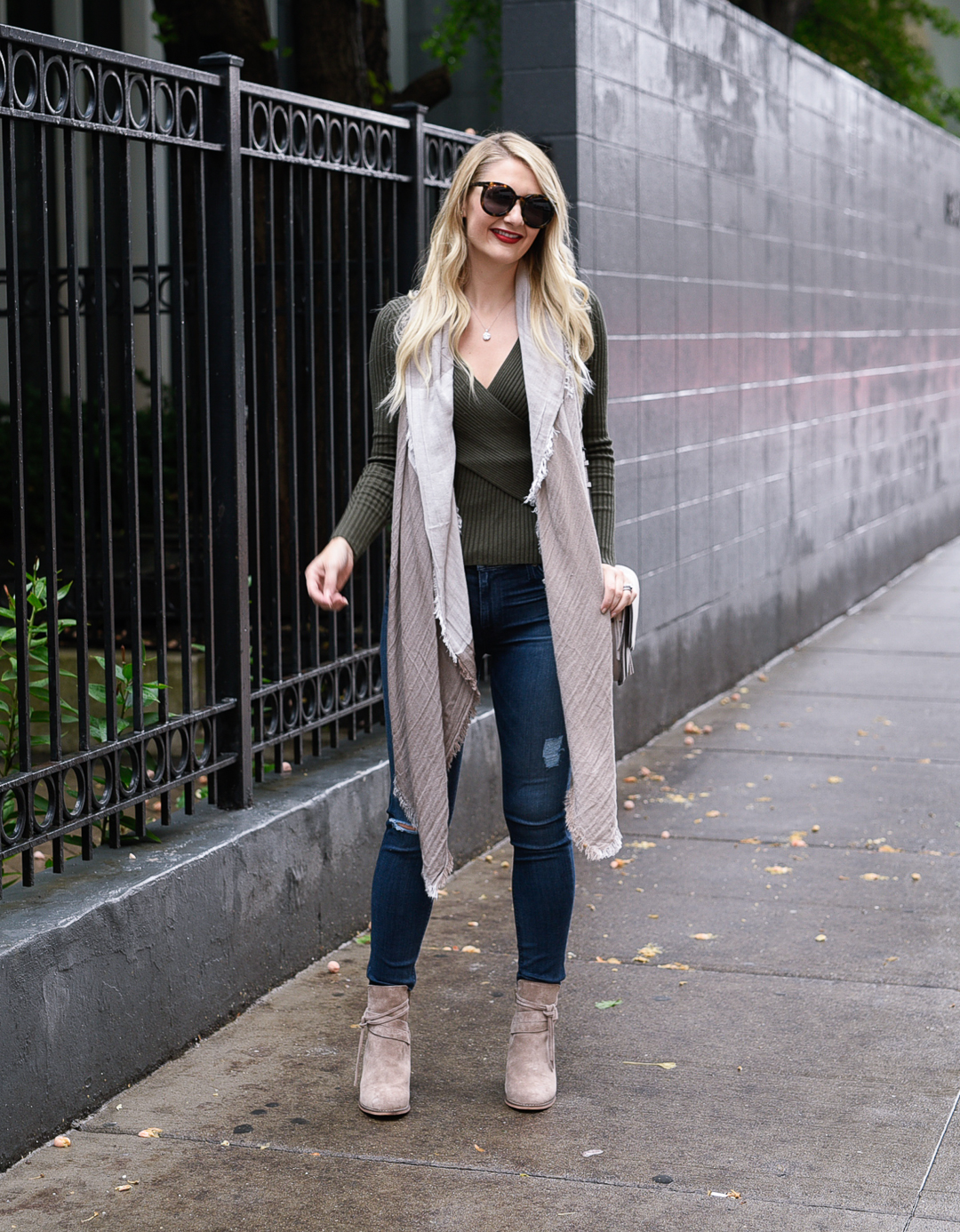 Jenna Colgrove in a green ribbed sweater, distressed jeans, and Sole Society booties in taupe.